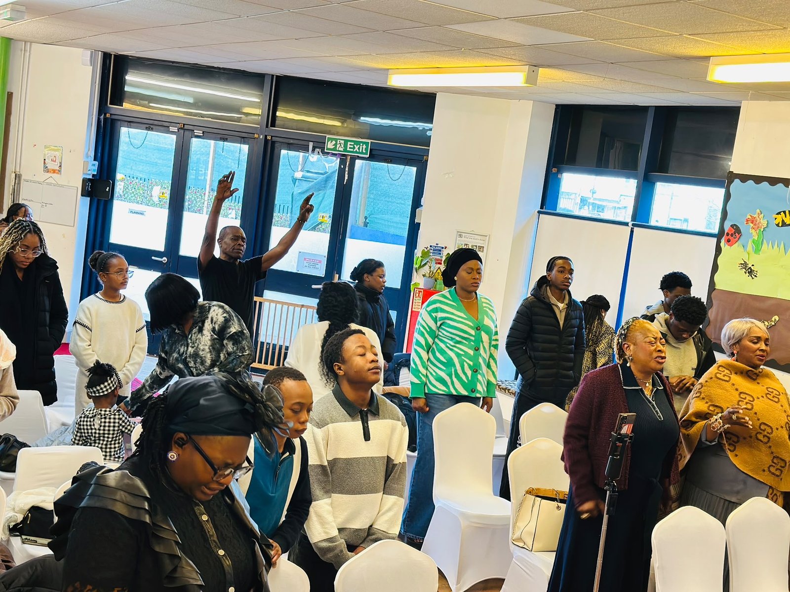 The congregation standing in worship on a Sunday