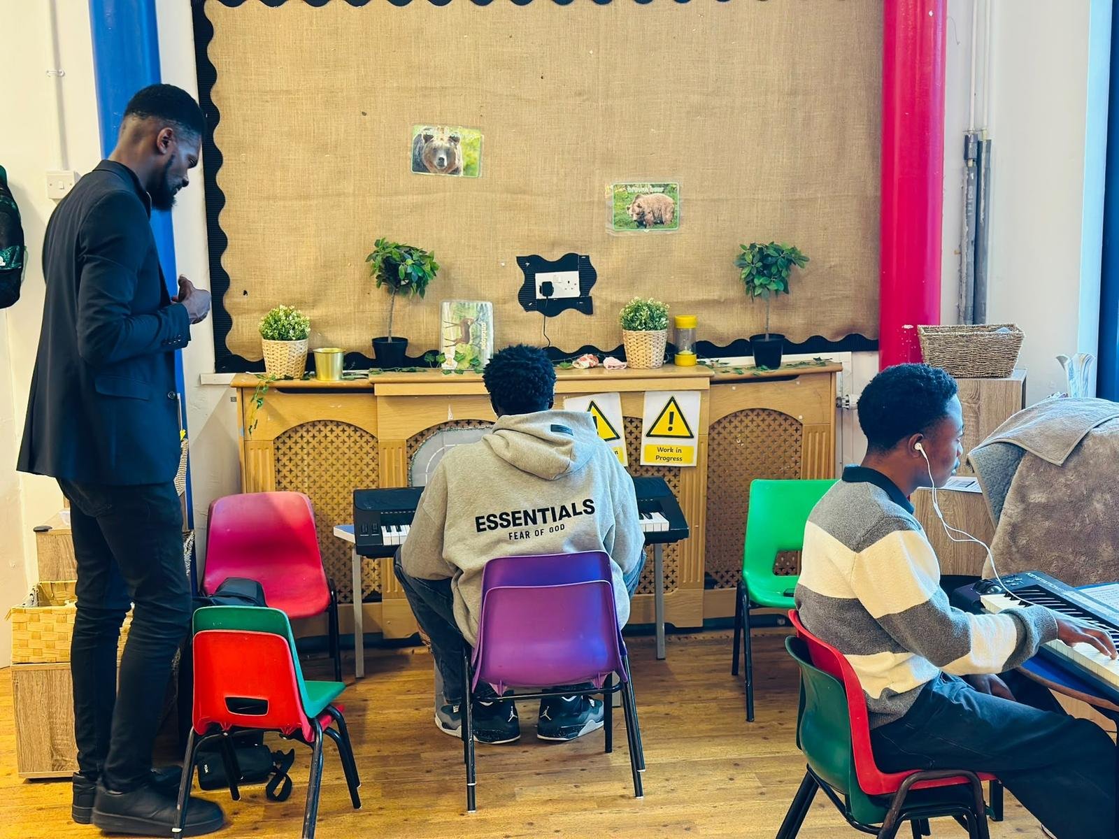Young people learning keyboard at a church music session